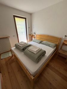 a bedroom with a large bed with towels on it at Il Cirmolo in Canale dʼAgordo