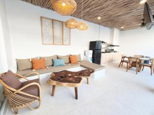 a living room with a couch and chairs and a table at Villa Chioni Uluwatu by LODGELINK BALI in Uluwatu