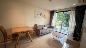 a living room with a couch and a table at Wonderful condo BTS Ekkamai 7min by walking in Bangkok