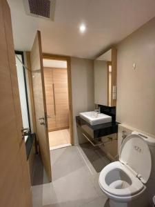 a bathroom with a toilet and a sink at Wonderful condo BTS Ekkamai 7min by walking in Bangkok +13 photos
