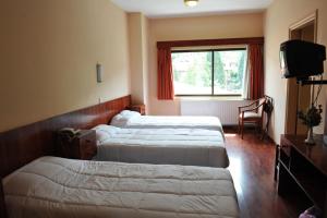 Voodi või voodid majutusasutuse Ekali Hotel toas