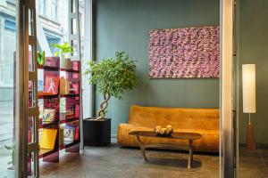 a living room with a couch and a table at Hotel Aqua by HappyCulture in Brussels