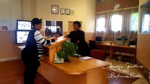 two women standing at a desk in an office at Boschdal Upmarket Guesthouse in Rustenburg
