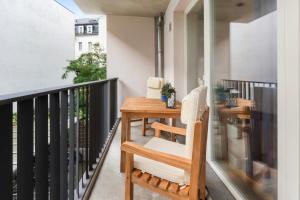 a balcony with a wooden table and a chair at Luxus im Zentrum für 6 Personen! 3 Zimmer, Balkon, WLAN, Parkplatz in Dresden