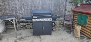 a bbq grill with a blue top on top of it at Casa Riquelme 2 in Alpedrete