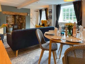 a living room with a table and a couch at Winkle Cottage in Calbourne +12 photos