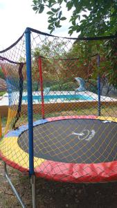 a net on a trampoline in a park at Chácara Encanto do Luar casa de 2 quartos in Rio Bonito