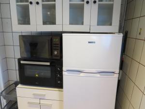 a kitchen with two microwaves and a refrigerator at LE GOELAND in Ault