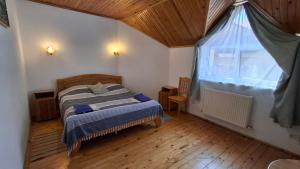 una camera da letto con un letto e una grande finestra di Oskolok Dovbusha Mini-Hotel a Jaremče