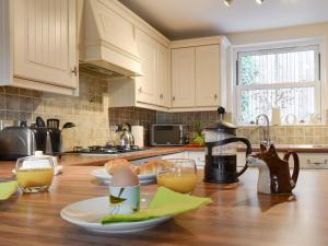 a kitchen with a wooden table with two glasses of orange juice at Rolton House in Ambleside +10 photos