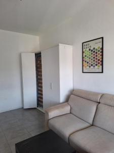 a living room with a couch and a table at Mini appartamento vicino al lago in Dormelletto