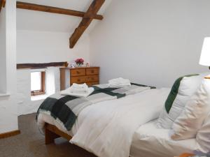 a bedroom with two white beds and a window at Ty Ceffylau - Uk46190 in Llanybydder +15 photos