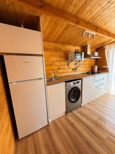 a kitchen with a refrigerator and a washing machine at Casas ROBRA in El Palmar