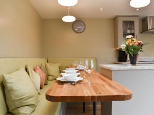 a dining room with a table and a couch at The Bothy in Beetham