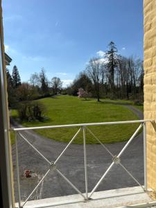 a view of a field from a porch with a fence at Château de Bellignies Diane in Bellignies +9 photos