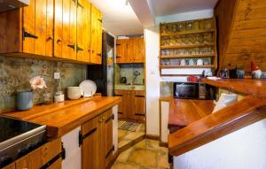 a kitchen with wooden cabinets and wooden counters at Villa Magic by Villas Guide in Jalžabet