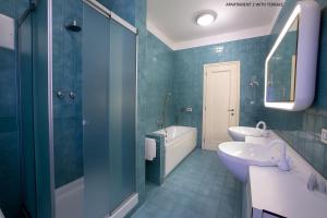 a blue bathroom with a sink and a toilet at DIMORA STORICA VICOLO DEL VOLTO in Iseo