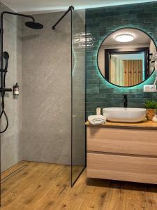 a bathroom with a sink and a mirror at Apartamenty Drewno i Kamień in Wetlina +37 photos