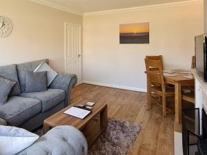 a living room with a couch and a table at Marrion House in Middleton