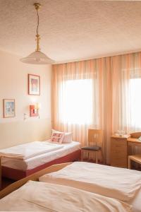 Postel nebo postele na pokoji v ubytování Hotel Leander