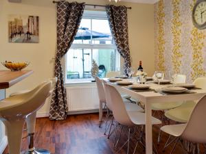 a dining room with a table and chairs and a window at The Horseshoes in Hornsea
