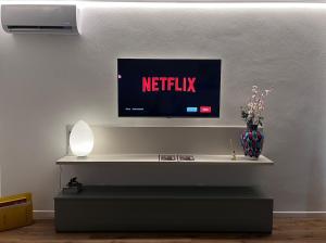 a television on a wall in a living room at Appartamento Palazzo in Mestre
