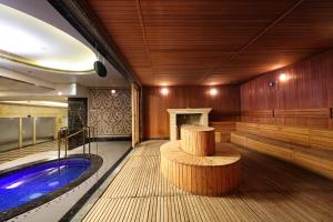 a swimming pool with a jacuzzi in a room at Royal Mediterranean Hotel in Guangzhou