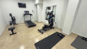 a gym with treadmills and exercise bikes in a room at Ponti Beach Hotel in Vasiliki
