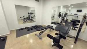 a gym with several treadmills and weights at Ponti Beach Hotel in Vasiliki