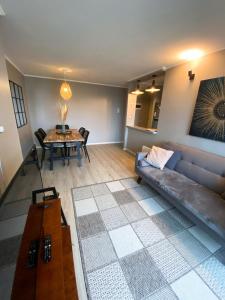 a living room with a couch and a table at Departamento Osorno 3D 2B 2 estacionamiento in Osorno +6 photos