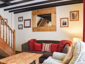 a living room with a couch and a table at Awd Tuts in Whitby