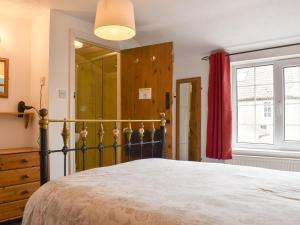 a bedroom with a large bed and a window at Awd Tuts in Whitby +8 photos