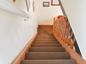 a winding staircase in a building with a stair case at Awd Tuts in Whitby
