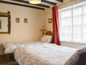 a bedroom with two beds and a window at Awd Tuts in Whitby