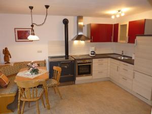 a kitchen with a table and a dining room at Ferienwohnung Hutterer in Bad Griesbach