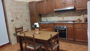 a kitchen with a wooden table and a stove at Terry's House in Fondi