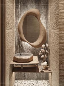 a bathroom with a stone sink and a mirror at Amber Cruise in Luxor