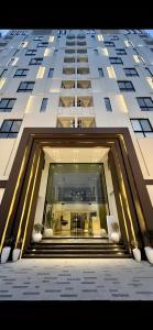 a tall building with a staircase leading into a lobby at Aurum Luxury Apartments Gulberg Lahore - LMY in Lahore