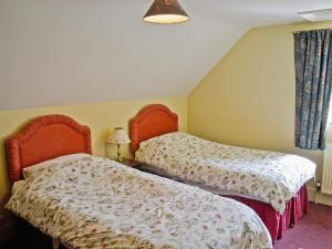 Ένα ή περισσότερα κρεβάτια σε δωμάτιο στο Westonbirt Cottage