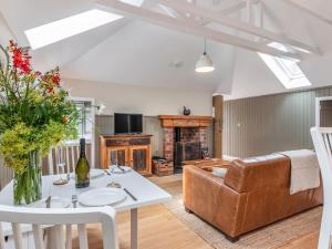 a living room with a couch and a table at The Granary - Uk34899 in Dunira