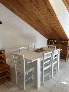 a white dining room table with white chairs at Apartments Renato in Vrboska +22 photos