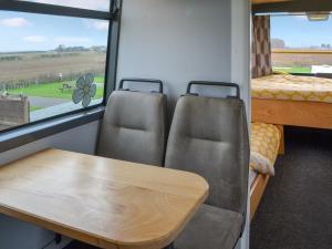 a table and chairs in a room with a window at Daisy Decker - Uk48371 in Hollym