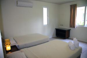Postel nebo postele na pokoji v ubytování Baan Talay Samran Baan D1
