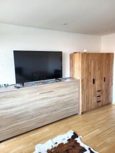 a large entertainment center with a large flat screen tv at Ferienwohnung Zum Hochgrat in Oberstaufen