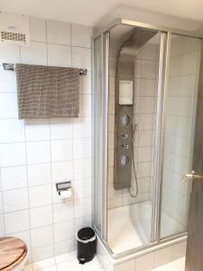 a shower with a glass door in a bathroom at Ferienwohnung Zum Hochgrat in Oberstaufen