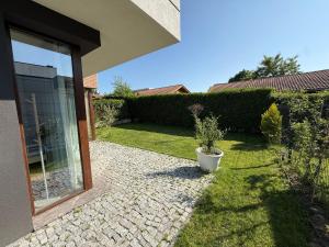 a patio with a potted plant next to a house at Вила Фамилия - Villa Family in Lozenets