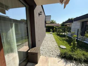 a glass door with a bench on a patio at Вила Фамилия - Villa Family in Lozenets