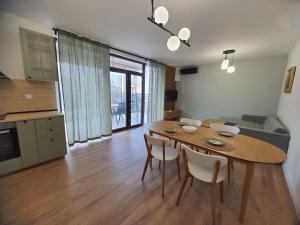 a kitchen and dining room with a table and chairs at Вила Фамилия - Villa Family in Lozenets +7 photos