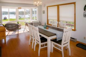 a dining room with a table and chairs at Green Acre on Lamoka Lake in Hammondsport