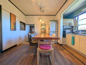 a living room with a table and a kitchen at 安樂-yasurai- in Otsu